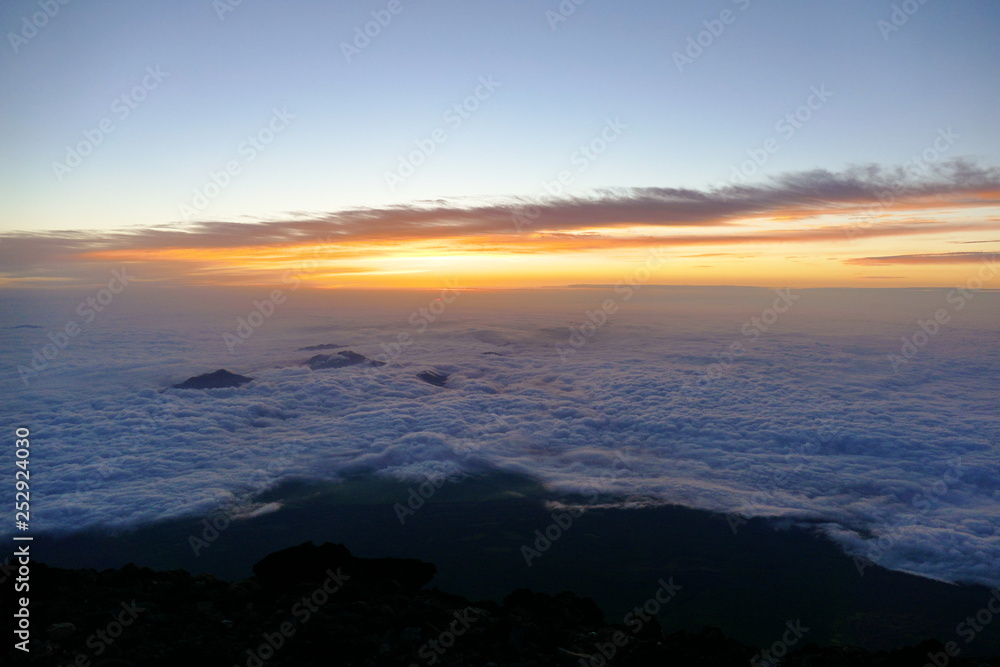 Sunrise over the clouds from the top of Mount Fuji, Japan
