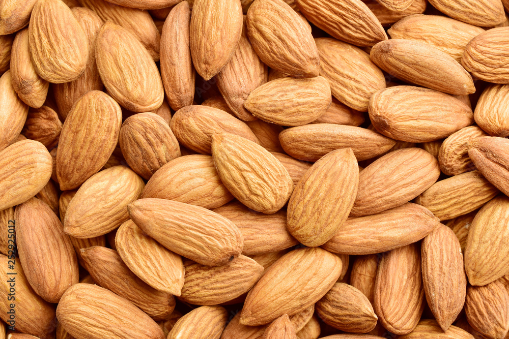 Organic texture of almonds. View from above.badam. Almonds macro. Almonds background Organic texture of almonds. View from above.badam. Almonds macro. Almonds background