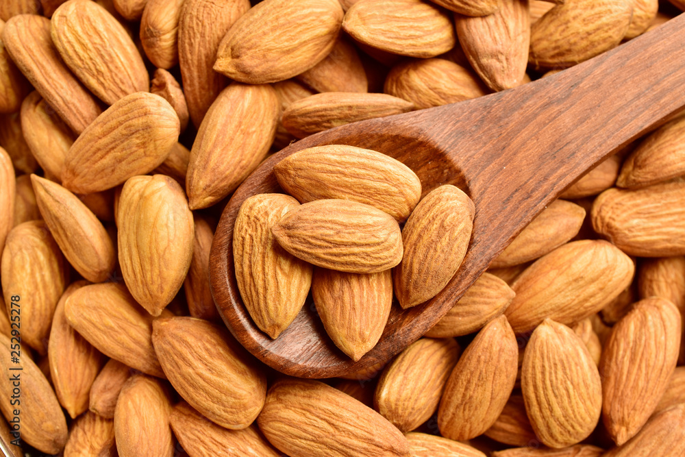 Almonds in wooden spoon, top view Almonds in wooden spoon, top view
