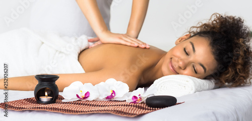Woman enjoying aroma massage in spa salon