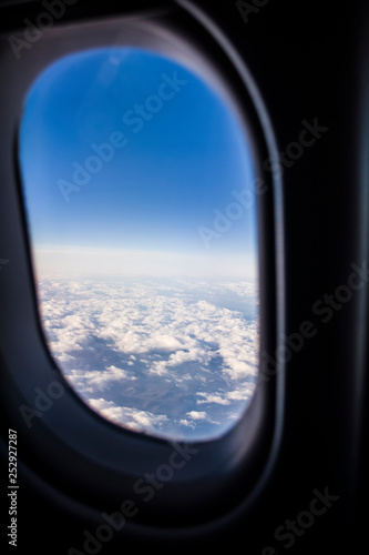 View from a window of the passenger plane on the sky and the earth from height. Beautiful view from air. Clouds and blue sky.