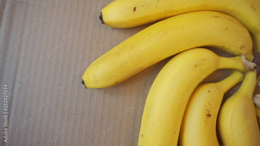 ripe banana fruits lie on the cardboard surface.view from above ripe banana fruits lie on the cardboard surface.view from above