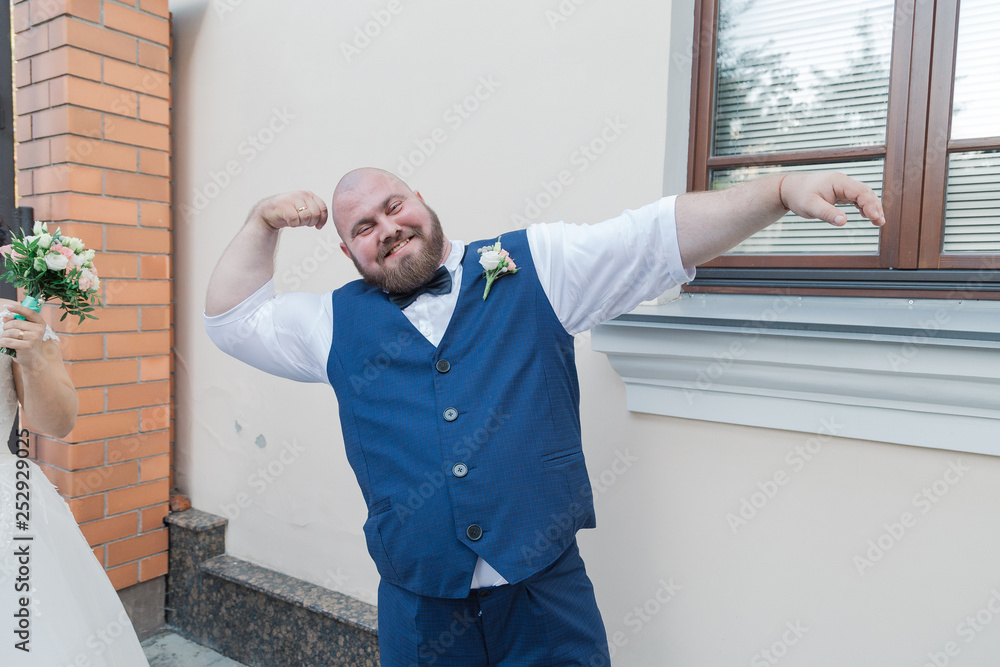 Portrait of a fat man with suspenders on his pants.