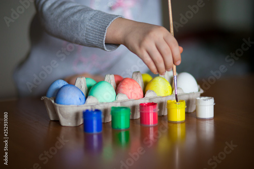 Happy easter. Little girl painter painted eggs. Kid preparing for Easter. Painted hand. Art and craft concept. Traditional spring holiday food