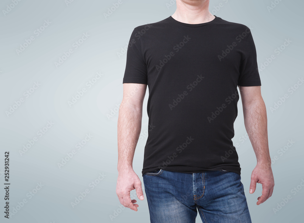 Man wearing blank black shirt with copy space isolated. T shirt design and people concept - close up of men in blank shirt. For mock up template design. Front view Man wearing blank black shirt with copy space isolated. T shirt design and people concept - close up of men in blank shirt. For mock up template design. Front view