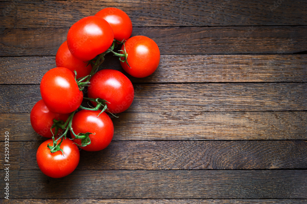 Tomatoes on wooden table with copy space Tomatoes on wooden table with copy space
