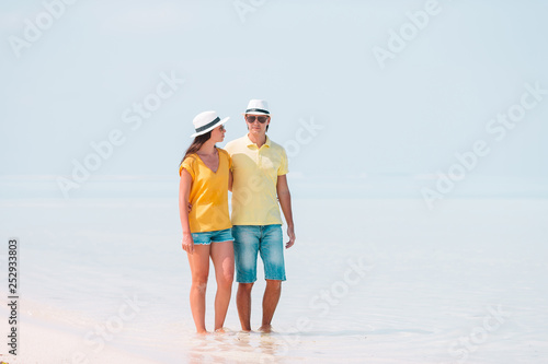 Young Family on white beach during summer vacation.