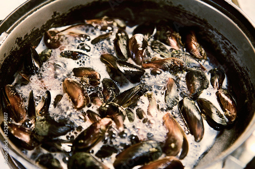 Mussels are fried in a skillet. Cooking in the kitchen. Seafood. asian food