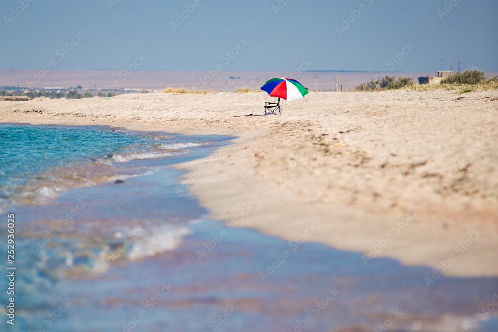 holidays at the sea and beach landscape with colored sun umbrella holidays at the sea and beach landscape with colored sun umbrella