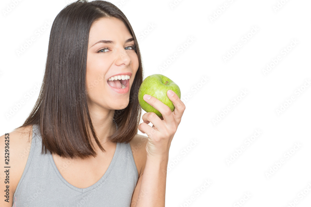 I choose health. Closeup studio portrait of a beautiful brunette going to bite a green apple looking to the camera cheerfully I choose health. Closeup studio portrait of a beautiful brunette going to bite a green apple looking to the camera cheerfully