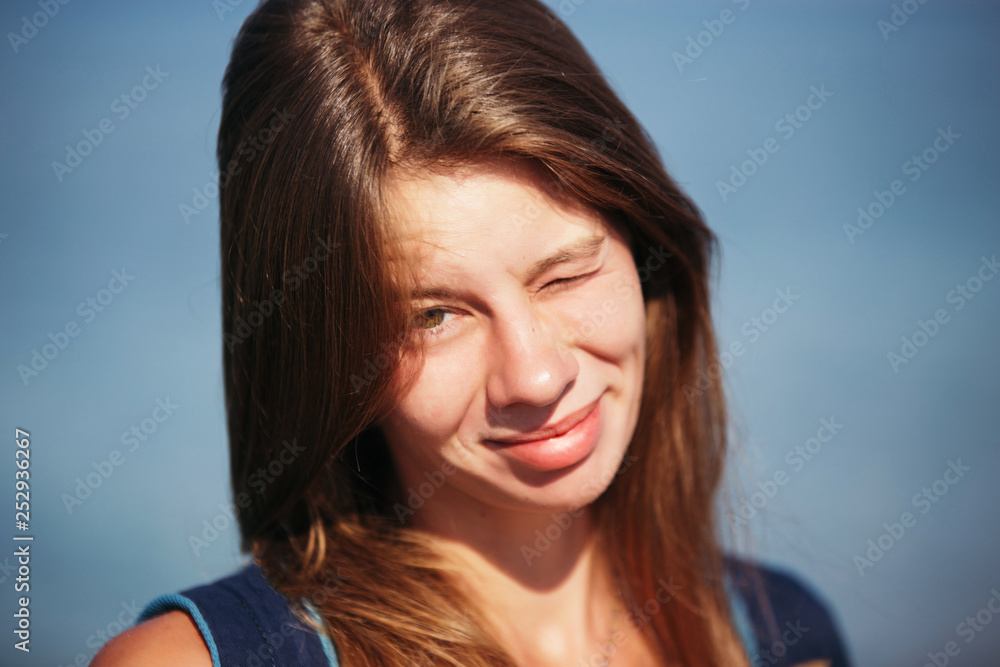 portrait of smiling pretty girl with long hair standing on the beach portrait of smiling pretty girl with long hair standing on the beach
