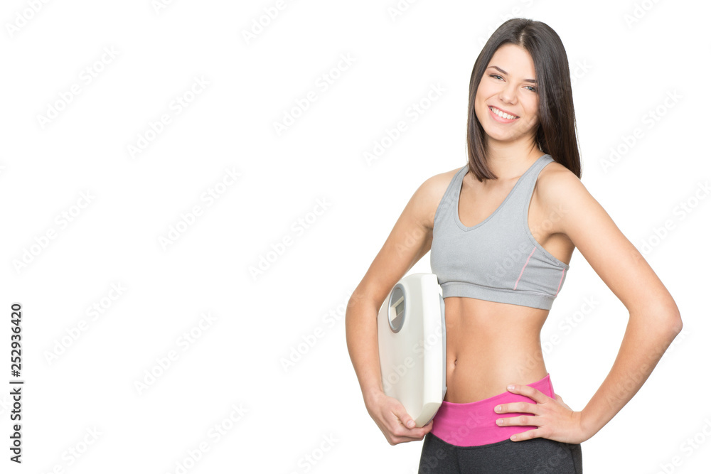 Diet and exercise. Portrait of a young fitness woman holding scales and smiling happily isolated on white copyspace on the side Diet and exercise. Portrait of a young fitness woman holding scales and smiling happily isolated on white copyspace on the side