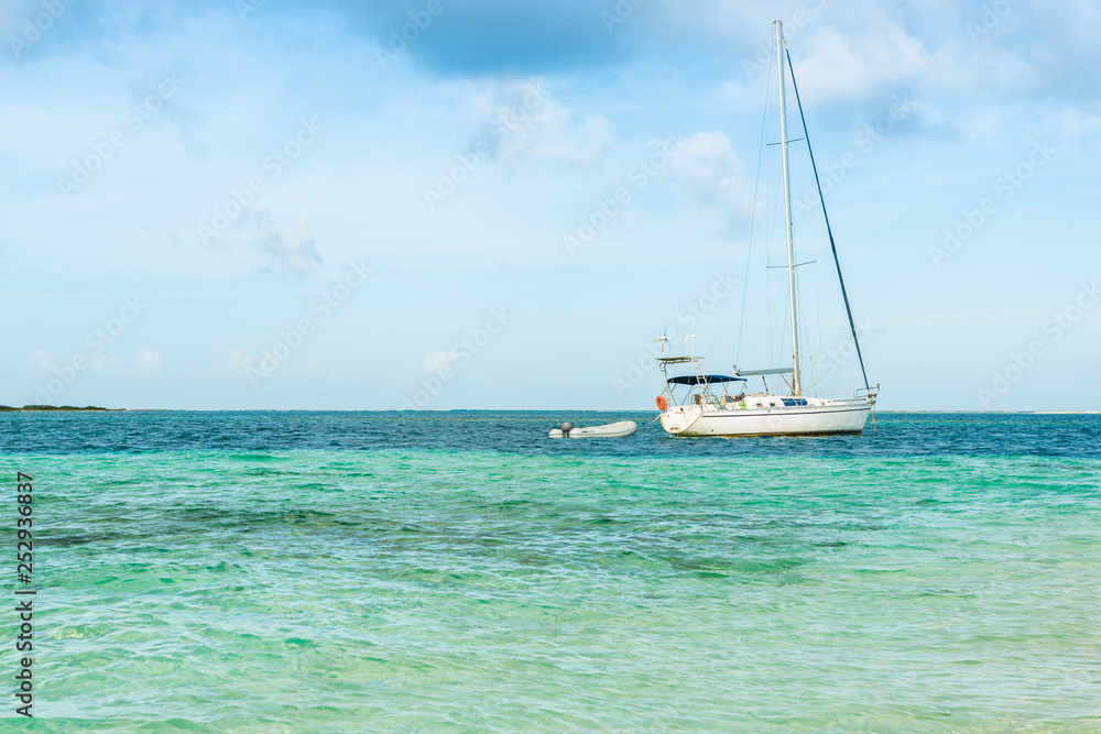 Yachts anchored in turquoise waters at Las Aves Island, Venezuela. The Aves Island is a small Venezuelan island of 4.5 hectares located in the Caribbean Sea. 