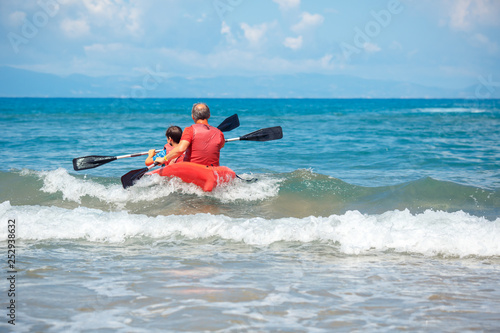 Father and son kayaking in ocean. Active vacation with young kid. Holiday activity with schoolboy child