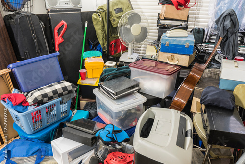 Hoarder home packed with stored boxes, vintage electronics, files, business equipment and household items. photo