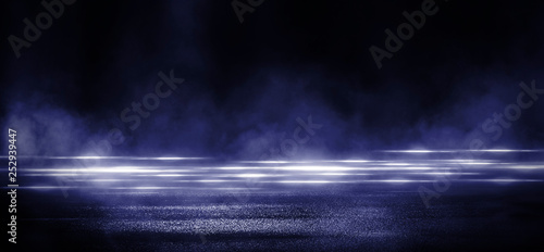 Wet asphalt, reflection of neon lights, a searchlight, smoke. Abstract light in a dark empty street with smoke, smog. Dark background scene of empty street, night view, night city. © MiaStendal