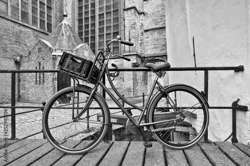 Retro style black bicycle parked against a railing, Gouda, The Netherlands