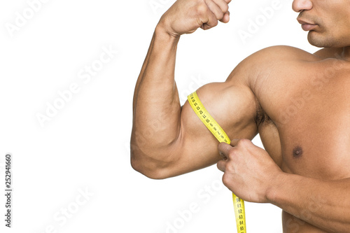 Photography Check those muscles! Cropped shot of a ripped bodybuilder measuring his biceps i