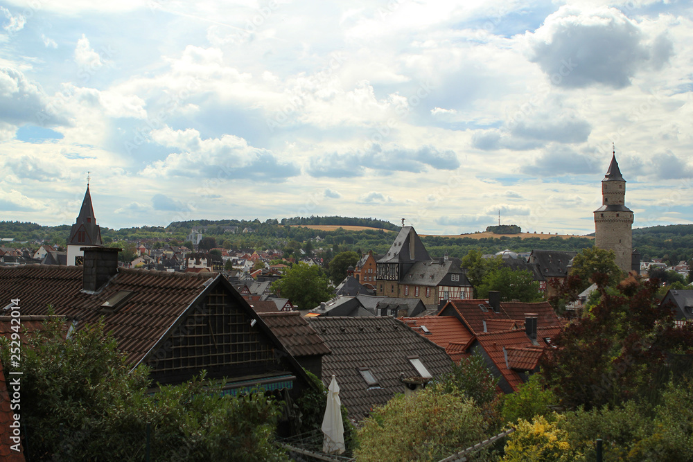 View from the high wall down to the interesting half-timbered houses of medieval Europe. A small tourist town of Germany, 2018