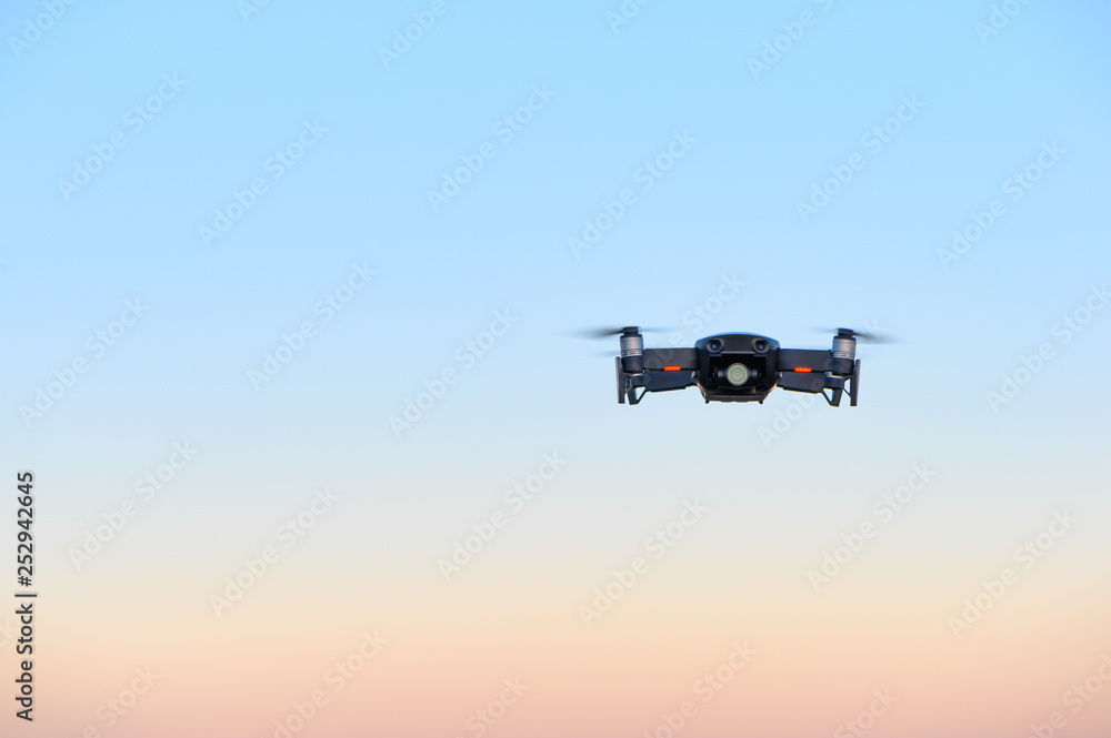 small drone in front of magical sunset sky small drone in front of magical sunset sky