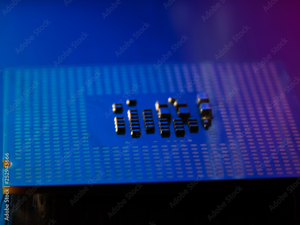 CPU processor pins up in blue and red light close-up CPU processor pins up in blue and red light close-up
