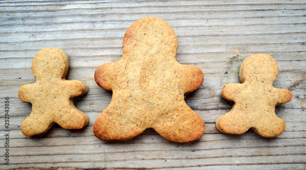Gingerbread cookies in shape of man on wooden table Gingerbread cookies in shape of man on wooden table