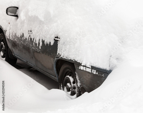 Car in the snowdrift on the parking lot