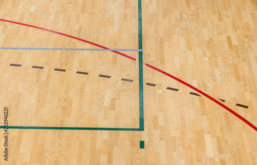 wooden floor badminton, futsal, handball, volleyball, football, soccer court. Wooden floor of sports hall with marking red lines on wooden floor indoor, gym court