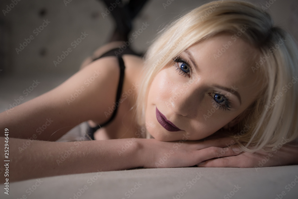 Portrait of a young girl in sexy lingerie lying in bed in lace and tights posing for a boudoir shot Portrait of a young girl in sexy lingerie lying in bed in lace and tights posing for a boudoir shot
