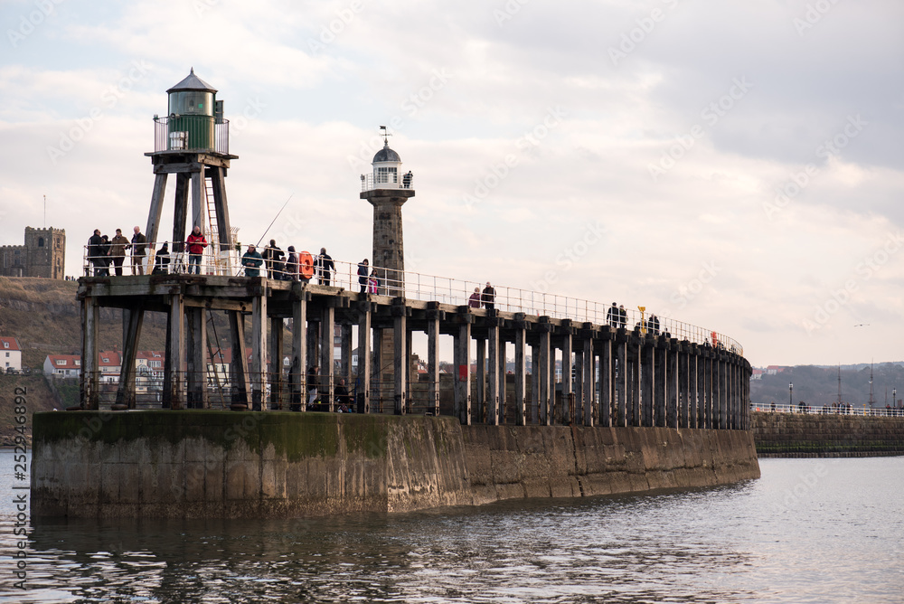 Fishmen and lighthouse, Whitby, UK
