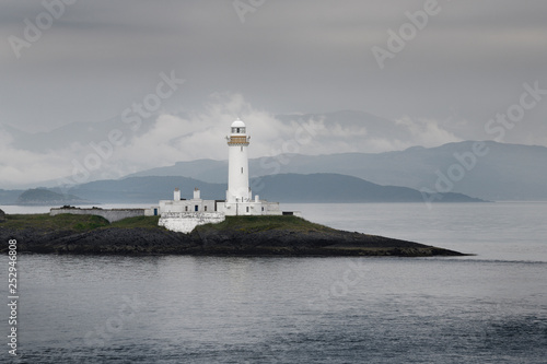 Lismore Lighthouse on Eilean Musdile Islet off Lismore Island with rain and mist over the west coast highlands Scotland UK