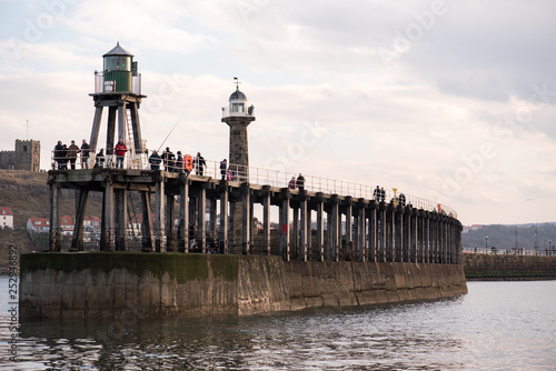 Obraz na płótnie Fishmen and lighthouse, Whitby, UK w salonie