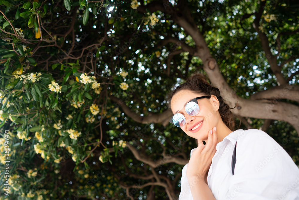 beautiful young girl posing on the background of evergreen tree beautiful young girl posing on the background of evergreen tree
