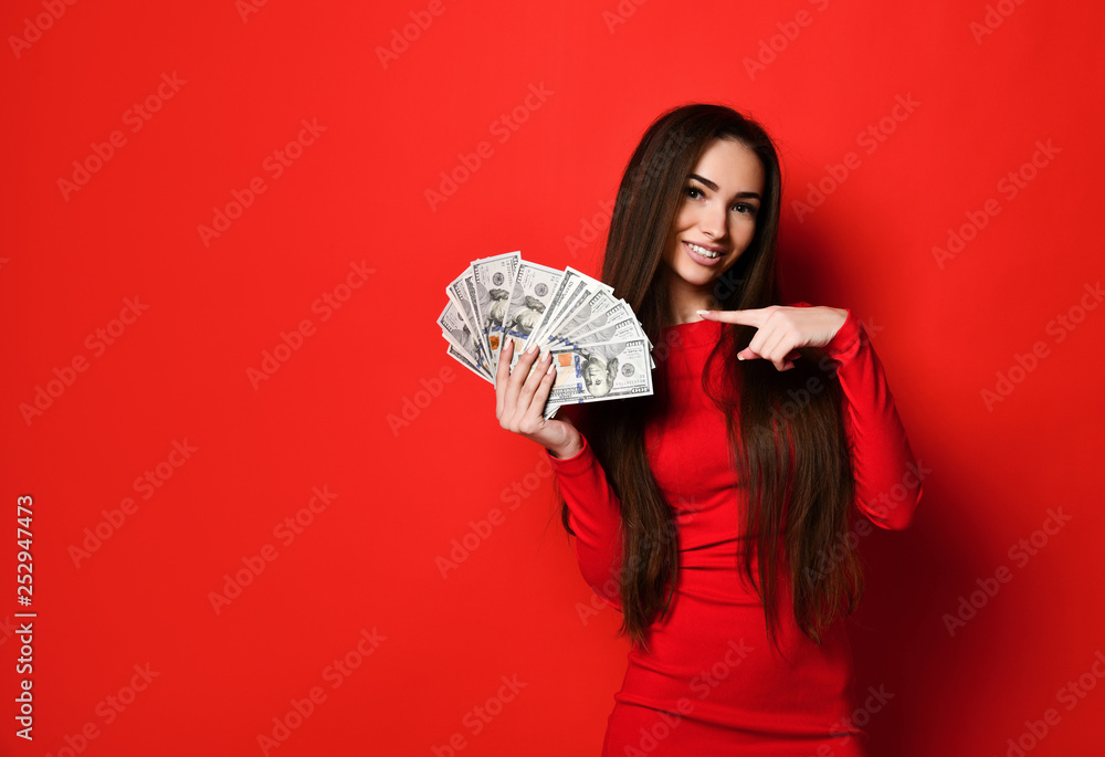 pretty woman in red dress holding bunch of money banknotes Photos | Adobe  Stock