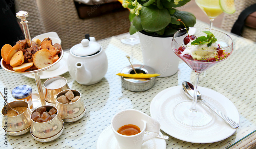 Fototapeta premium Breakfast with tea, coffee, different biscuits and cookies, and ice cream