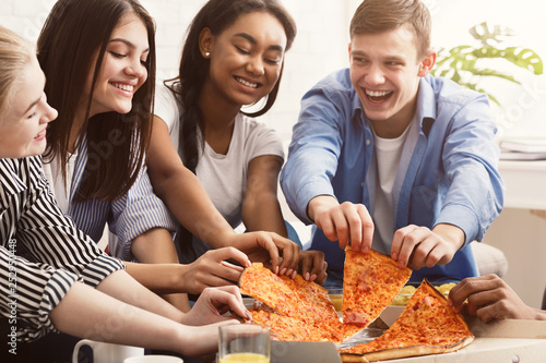 Friends eating pizza  spending time together at home