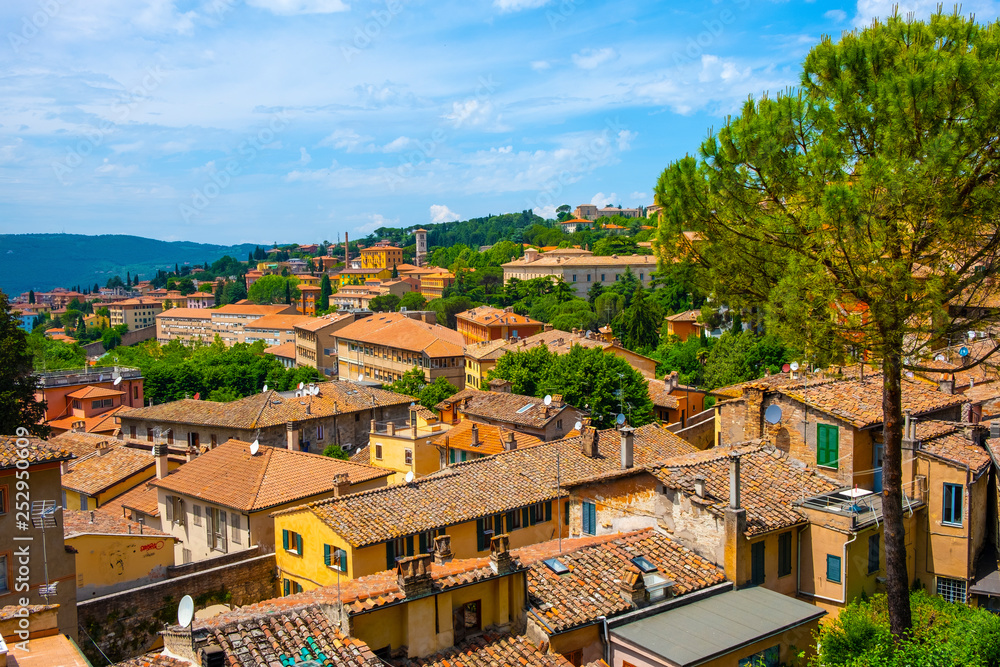 Fototapeta premium Perugia, Italy - Panoramic view of the Perugia historic quarter with medieval houses and Umbria valleys and mountains in background