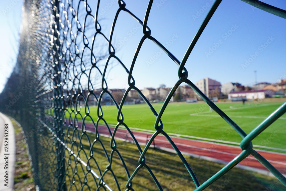 Green wire fence at the football pitch close up view Green wire fence at the football pitch close up view