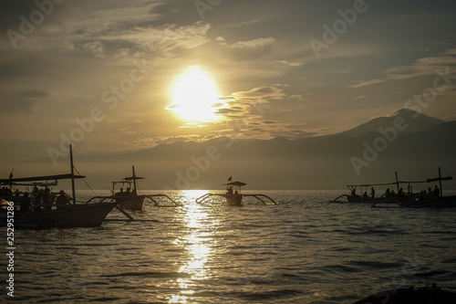 Traditional balinese fisherman's boats on sunrise in the ocean, Lovina, north of Bali, Indonesia