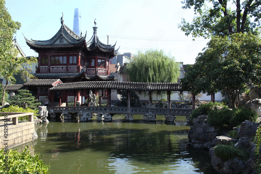 Traditional chinese garden with beautiful bridge aver a pond