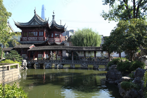 Traditional chinese garden with beautiful bridge aver a pond