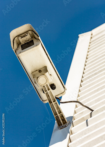 Modern CCTV camera on the wall of an industrial building