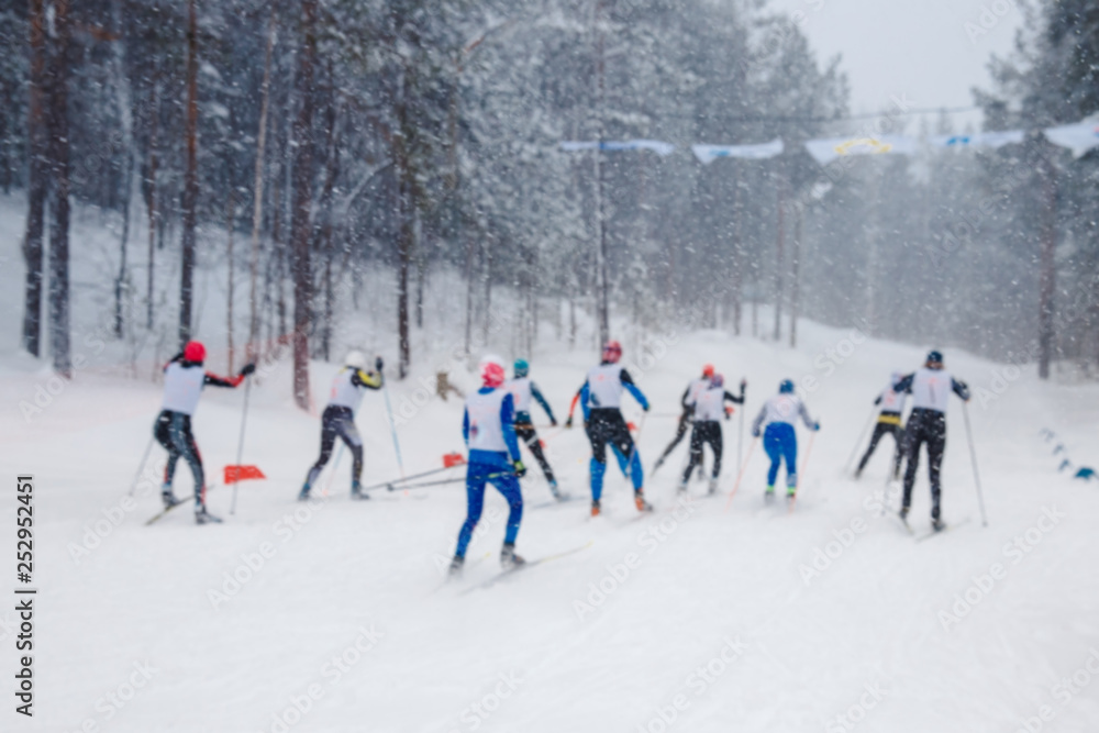 Men run skiing start. Blurred background frame. Winter day, snowing heavily Men run skiing start. Blurred background frame. Winter day, snowing heavily