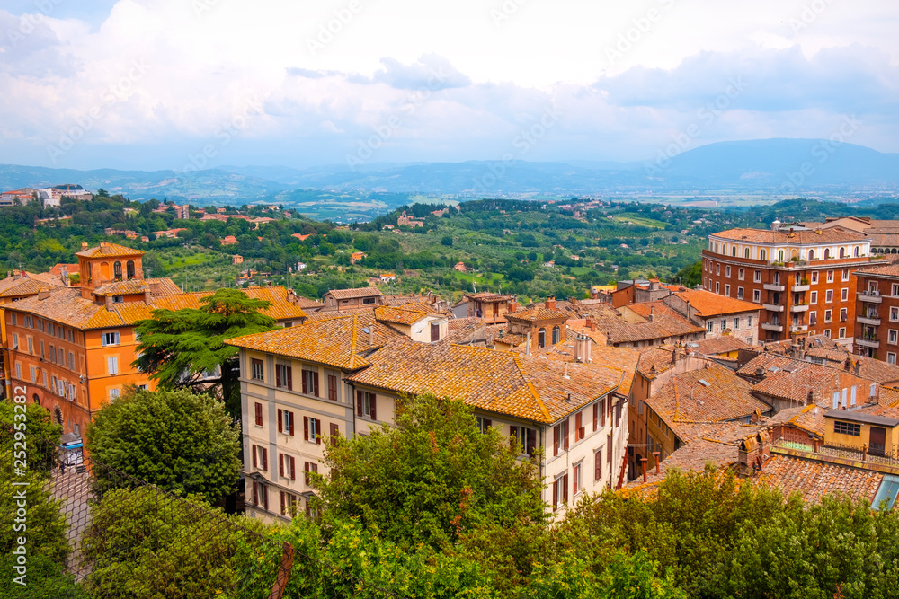 Perugia, Italy - Panoramic view of the Perugia historic quarter with medieval houses and Umbria valleys and mountains in background