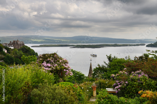 Hilltop garden view of Tobermory harbour on Isle of Mull with Calve Island in the Sound of Mull Inner Hebrides Scotland UK
