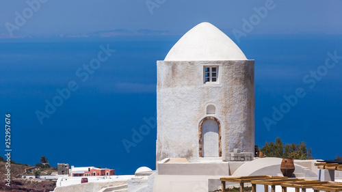 Old windmill against blue sky and sea  Santorini  Greece