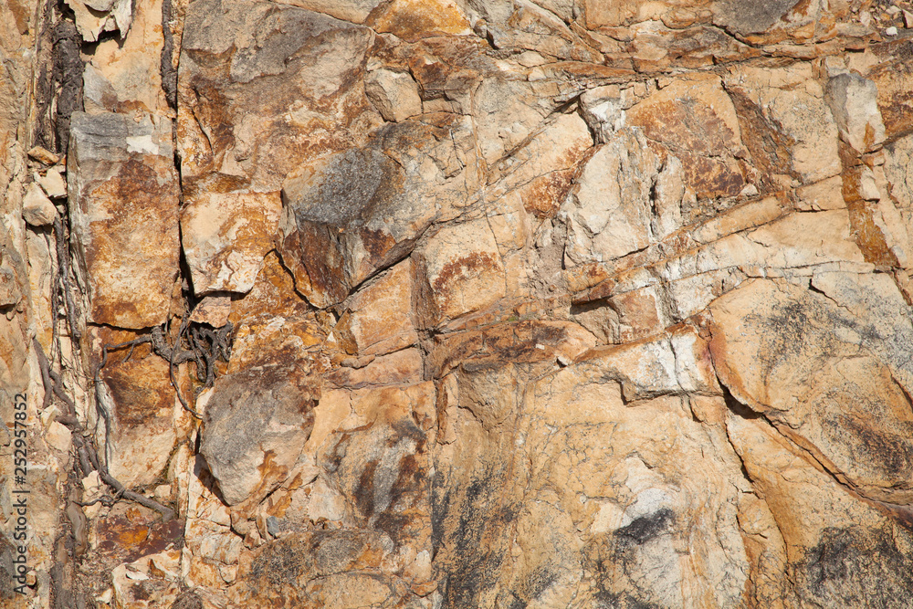 Natural background with rough brown stone surface Natural background with rough brown stone surface