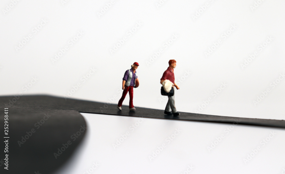 Miniature people walking along the way. Miniature people walking along the way.