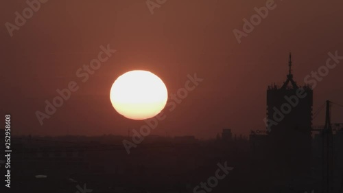 Beautiful timelapse of a sunset over city buildings