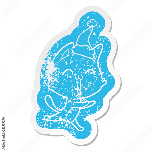 happy cartoon distressed sticker of a cat meowing wearing santa hat